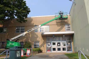 A green lift extends to the front facade of Lansing Elementary School