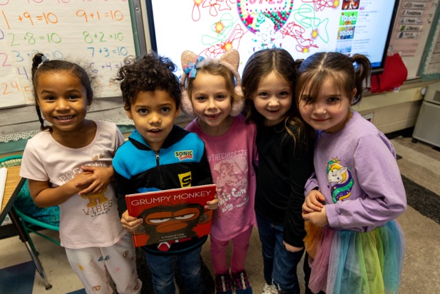 Five students from Abram Lansing Elementary School smile