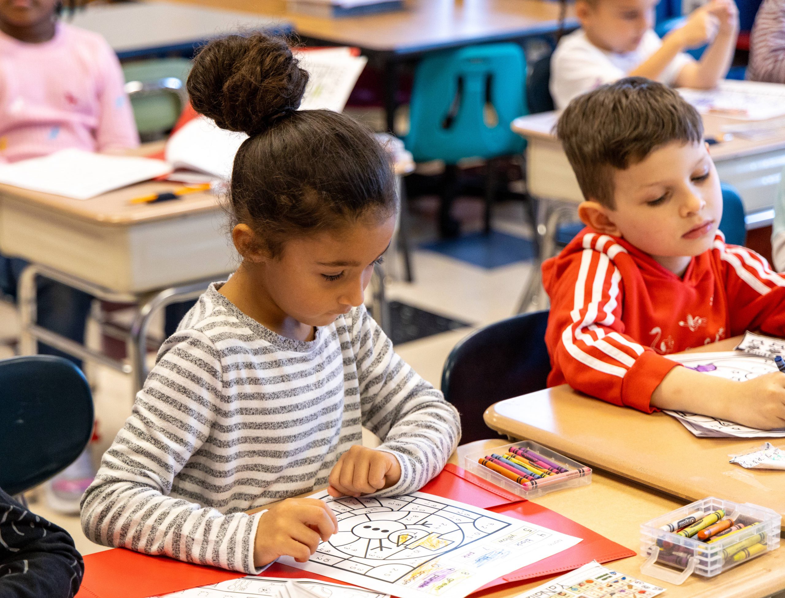 Two students work on their classwork