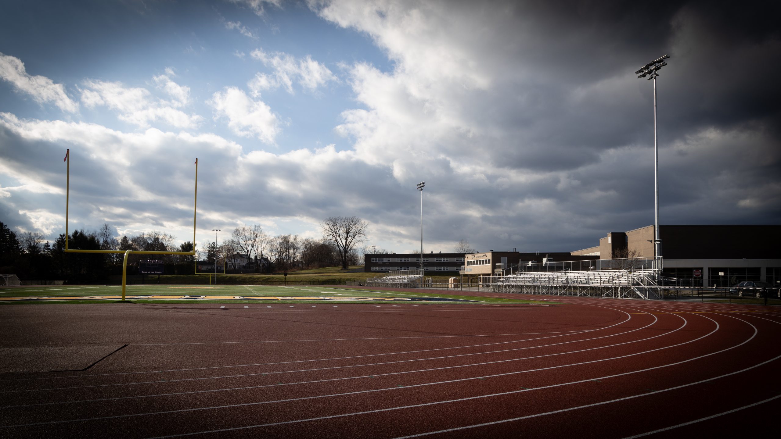 an empty, newly constructed track with bleachers.